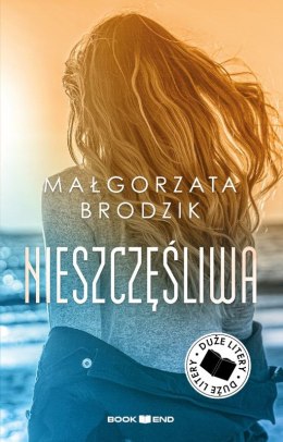 Nieszczęśliwa. Duże Litery